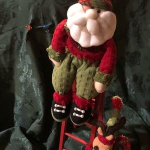 Santa on a ladder with his buddy.